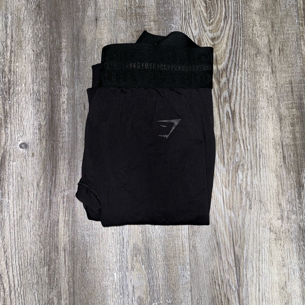 Gym shark leggings with font gym shark all over them.